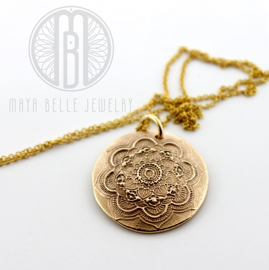 mandala pattern handcrafted on a gold necklace
